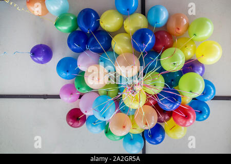 Beam of bright, beautiful balloons on the ceiling in the room. Stock Photo