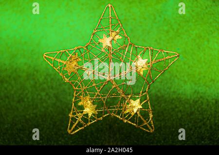 Christmas golden star decorations on Chive herbal green background. Stock Photo