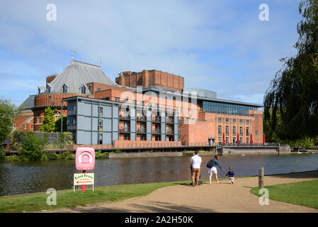 Young Couple with Child or Family Walking Along the Footpath on the Banks of River Avon in front of the Royal Shakespeare Theatre Stratford-upon-Avon Stock Photo