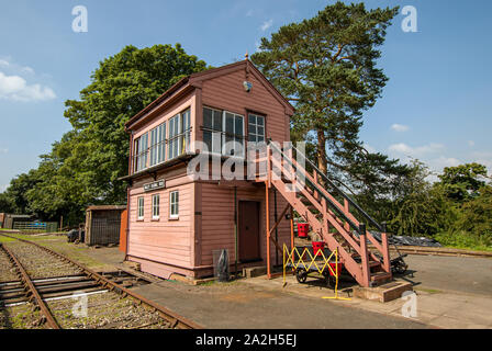 Old wooden railway signal box by the side of a railway track in Summer Stock Photo