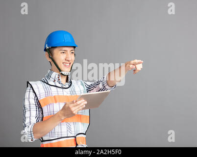 smiling asian young man construction worker Stock Photo