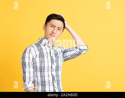 confused asian young man thinking Stock Photo
