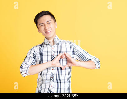 young man making heart gesture on his chest Stock Photo