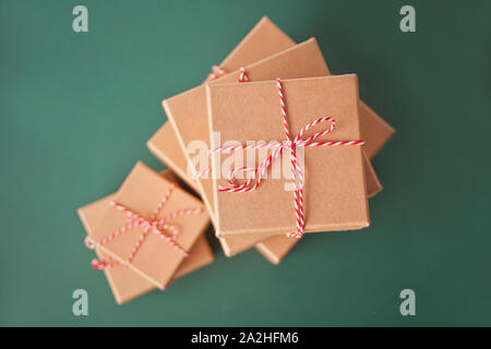 Five different sizes Christmas gift boxes on the green background. Stock Photo