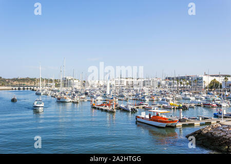 Marina de Lagos, Lagos, Algarve, Portugal. Small boats moored in the marina. Stock Photo