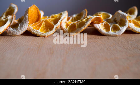 Natural Oranges Dried Sliced on a Wooden Background Stock Photo