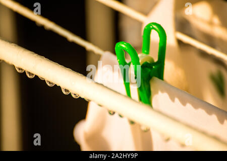 drying rack on a balcony with raindrops Stock Photo