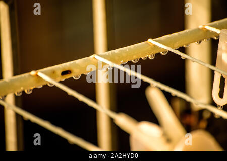 drying rack on a balcony with raindrops Stock Photo