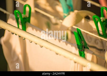 drying rack on a balcony with raindrops Stock Photo