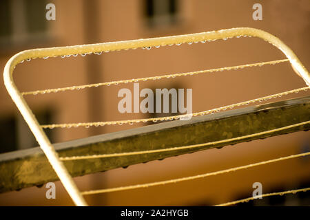 drying rack on a balcony with raindrops Stock Photo