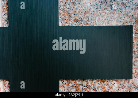 Black metallic geometric figure on granite background Stock Photo