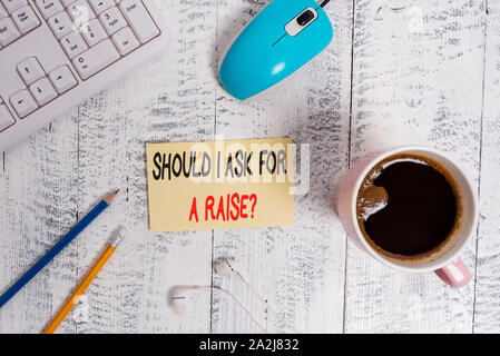 Conceptual hand writing showing Should I Ask For A Raise Question. Concept meaning deanalysisding increase in your month salary Technological devices Stock Photo