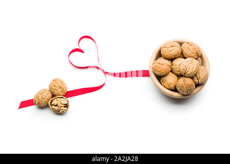 Three nuts a day for heart health, walnuts on bowl on white background Stock Photo