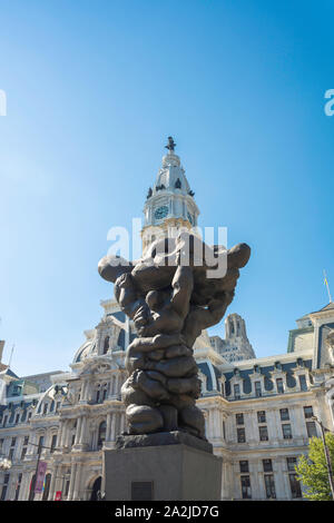 Philadelphia downtown, view of the sculpture titled We The People in Municipal Services Building Plaza with City Hall at rear, Philadelphia, PA USA Stock Photo