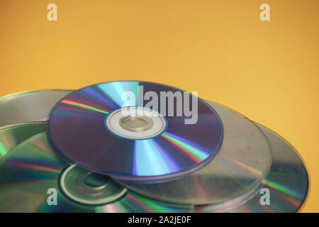 Close up Beautiful Old dirty CDs,DVD on yellow background. Stock Photo