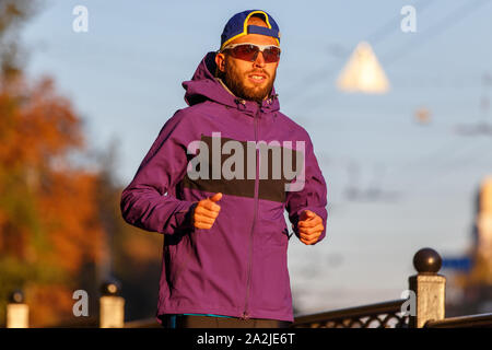 Sportsman running in the city in the morning. Healthy fitness lifestyle image Stock Photo