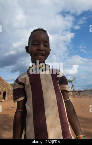 Turmi, Ethiopia - Nov 2018: Hamer tribe kid posing in striped t-shirt. Omo valley Stock Photo