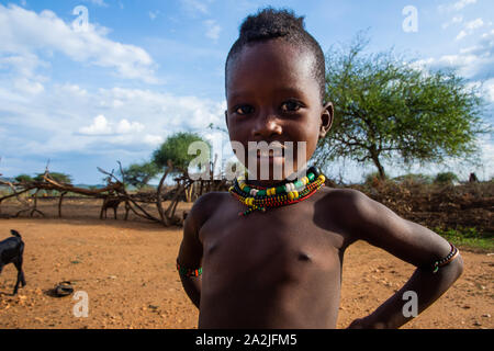 Turmi, Ethiopia - Nov 2018: Hamer tribe kid posing dressed in colorful necklaces and bracelets. Omo valley Stock Photo