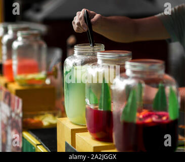 Close up of creative alcohol cocktails in glass jars on tap Stock Photo