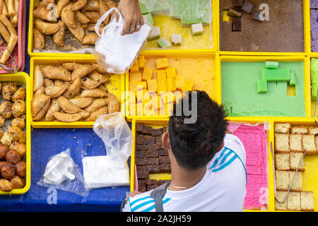 Top view of unidentified vendor at the food stall in Kota Kinabalu city food market. Stock Photo