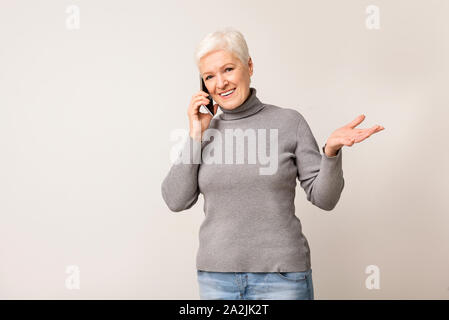 Attractive senior woman talking on mobile phone Stock Photo