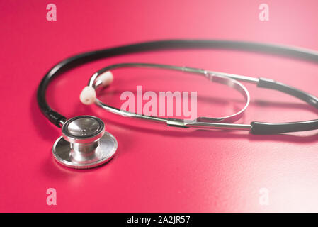 Stethoscope on a pink table. Concept of a medical examination and health care Stock Photo