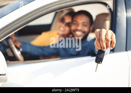 We bought car. Happy couple showing car key Stock Photo