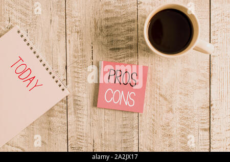 Conceptual hand writing showing Pros Cons. Concept meaning The favorable and unfavorable factors or reasons of demonstrating Stationary placed next to Stock Photo