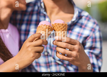Young couple eating ice cream cones together Stock Photo