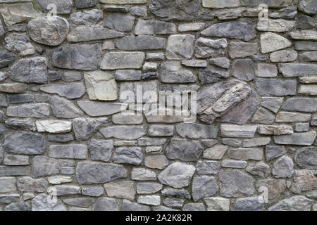 The wall of the house made of natural gray stone Stock Photo