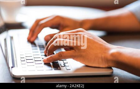 Male hands typing text or programming code on laptop Stock Photo