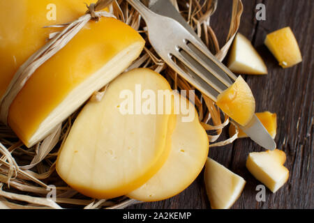 Scamorza, typical italian smoked cheese on wooden table Stock Photo