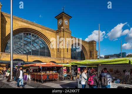 Kings Cross Station London Food Market, the front of London's Kings Cross Station, opened 1852. Food stalls in the station square. Stock Photo