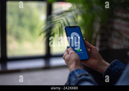 Woman is trying to encrypt her internet traffic with a VPN software Stock Photo