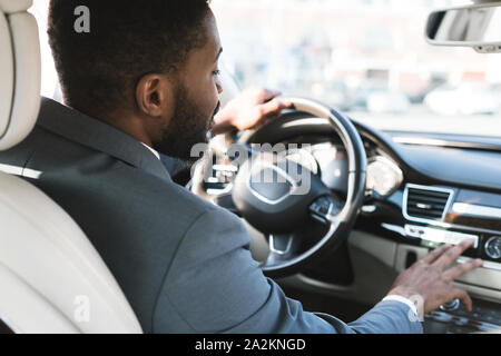 Driving with comfort. Businessman touching dashboard in car Stock Photo