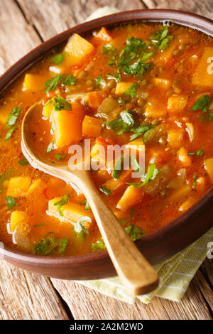 Moroccan Sweet Potato and Lentil Soup close-up on a plate on the table. Vertical Stock Photo