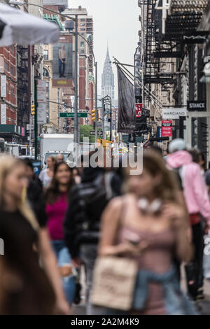 New York, NY, USA - May 17, 2018: Crowds of people walking sidewalk of Broadway avenue in Soho of Midtown Manhattan on may 17th, 2018 in New York City Stock Photo