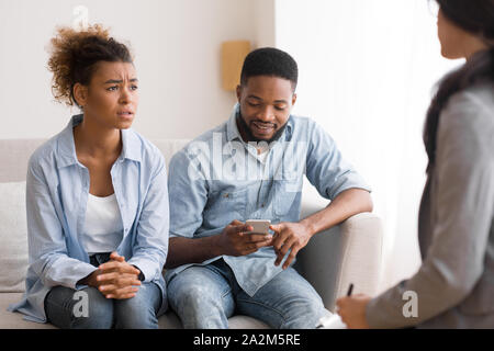 Sad Afro Woman Complaining Psychologist About Husband Indifference In Office Stock Photo