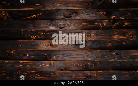 Burnt wooden board, black charcoal wood texture, burned barbecue background Stock Photo