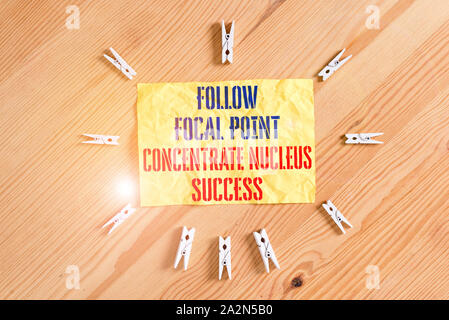 Writing note showing Follow Focal Point Concentrate Nucleus Success. Business concept for Concentration look for target Colored clothespin papers empt Stock Photo