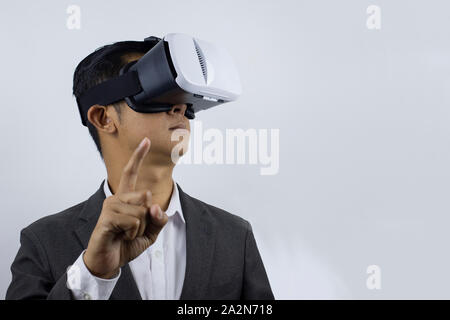Male in a suit with virtual reality glasses on his head. Isolated on white background. (selec tive fogus) Stock Photo
