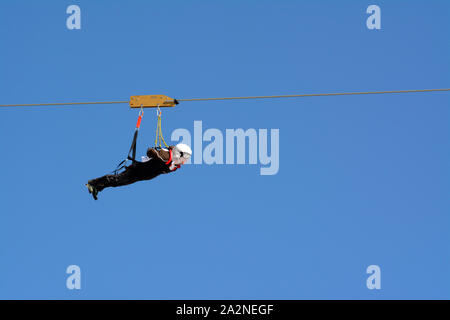 Person on Zip wire line, France Stock Photo