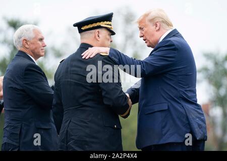 U.S President Donald Trump, right, and Vice President Mike Pence, left, congratulates incoming Chairman of the Joint Chiefs Gen. Mark Milley at Summerall Field, Joint Base Myer-Henderson Hall September 30, 2019 in Arlington, Virginia. Stock Photo