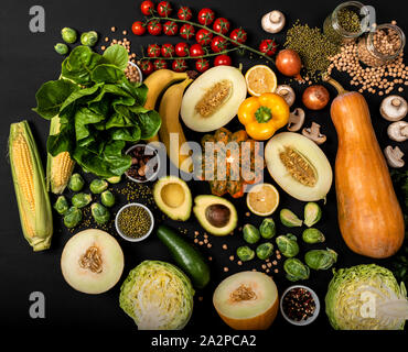 Collection of different fresh vegetables on a black background. Top view. Stock Photo