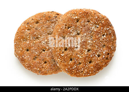 Two round oat wheat flat breads isolated on white. Top view. Stock Photo