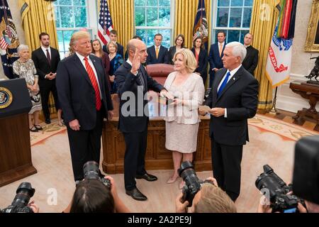 U.S. Labor Secretary Eugene Scalia, center, takes the oath of office from Vice President Mike Pence, right, as President Donald Trump looks on during a ceremony in the Oval Office of the White House September 30, 2019 in Washington, DC. Stock Photo