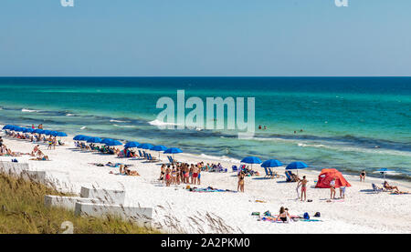 People on the white sand beach in Seaside, FL Stock Photo