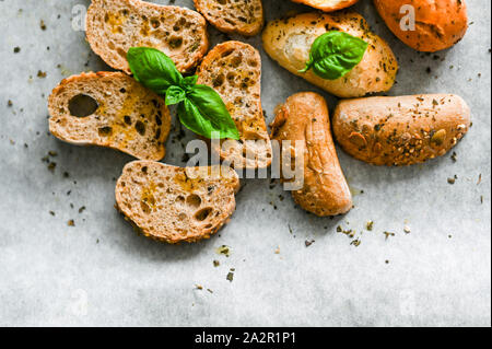 Oven baked bruschetta with basil and olive oil in the oven. Traditional italian appetizer. Top view Stock Photo