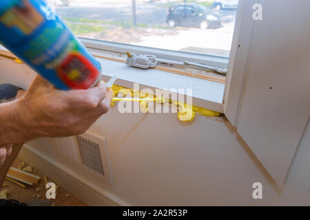 Construction PU foam in the window is installed using a mounting installation foam Stock Photo