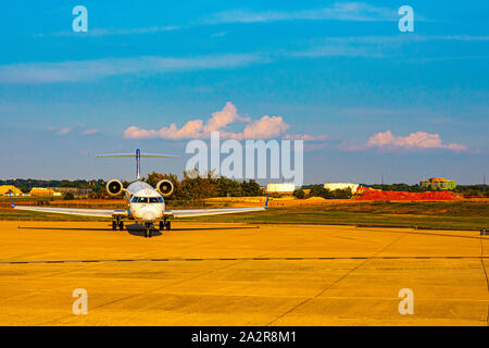 A passenger jet is stopped on the ground on a runway. Stock Photo
